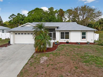 a view of a house with backyard and garden
