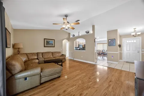 a living room with furniture and a wooden floor