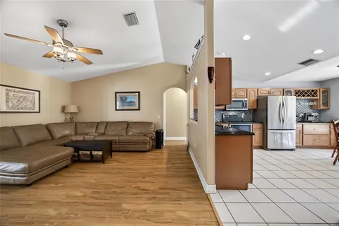a living room with furniture and kitchen view