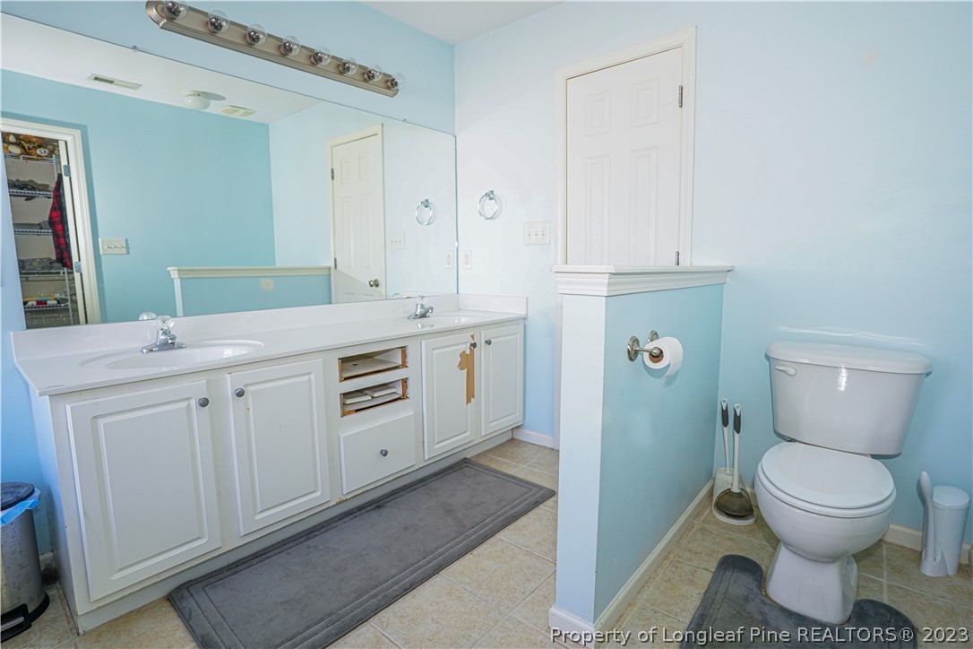 10 Pender Road Spring Lake, NC 28390 - Photo 11 of 30 a spacious bathroom with a toilet sink and mirror