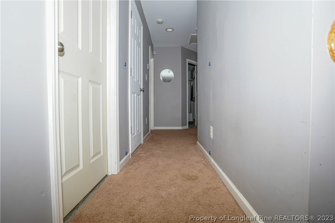 10 Pender Road Spring Lake, NC 28390 - Photo 17 of 30 a view of a hallway with wooden floor