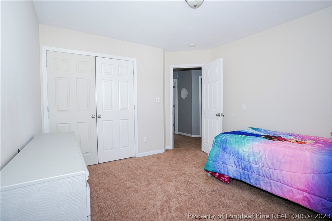 10 Pender Road Spring Lake, NC 28390 - Photo 18 of 30 a bedroom with a bed and a closet