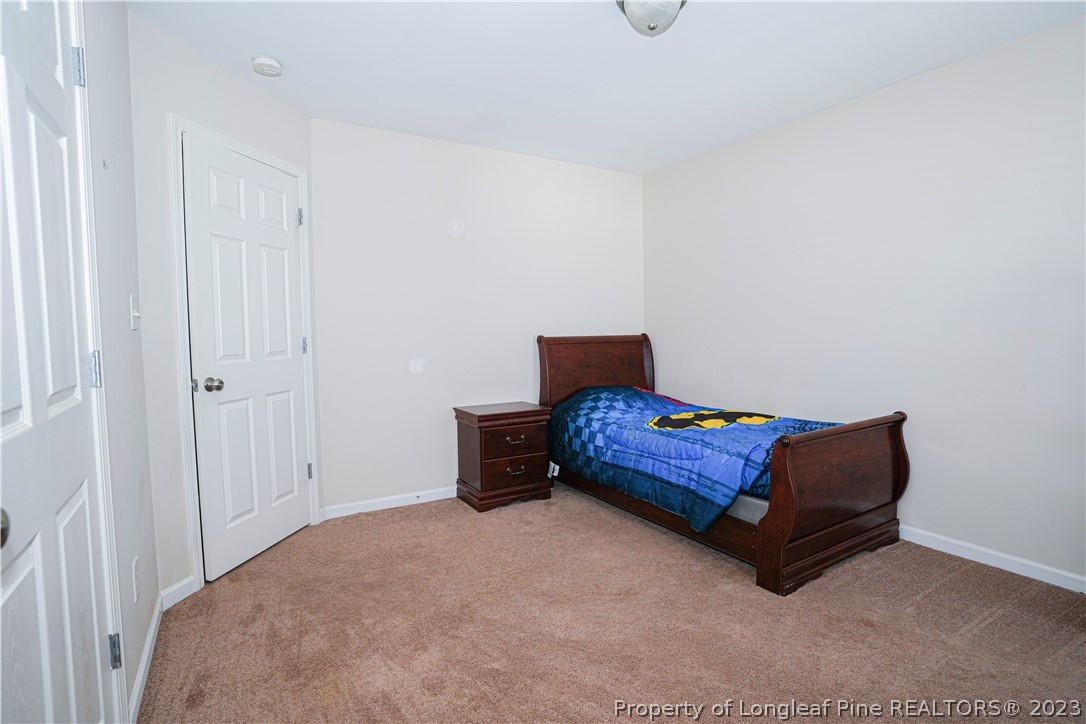 10 Pender Road Spring Lake, NC 28390 - Photo 21 of 30 a living room with a couch and a dresser with wooden floor