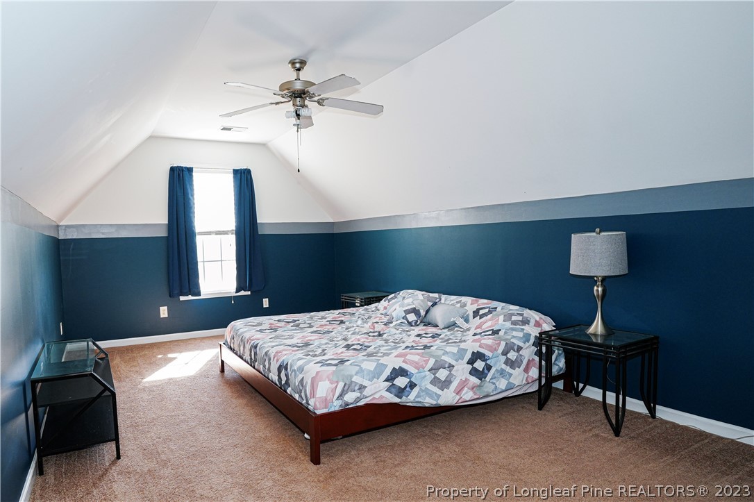 10 Pender Road Spring Lake, NC 28390 - Photo 23 of 30 a bedroom with a bed and a chandelier