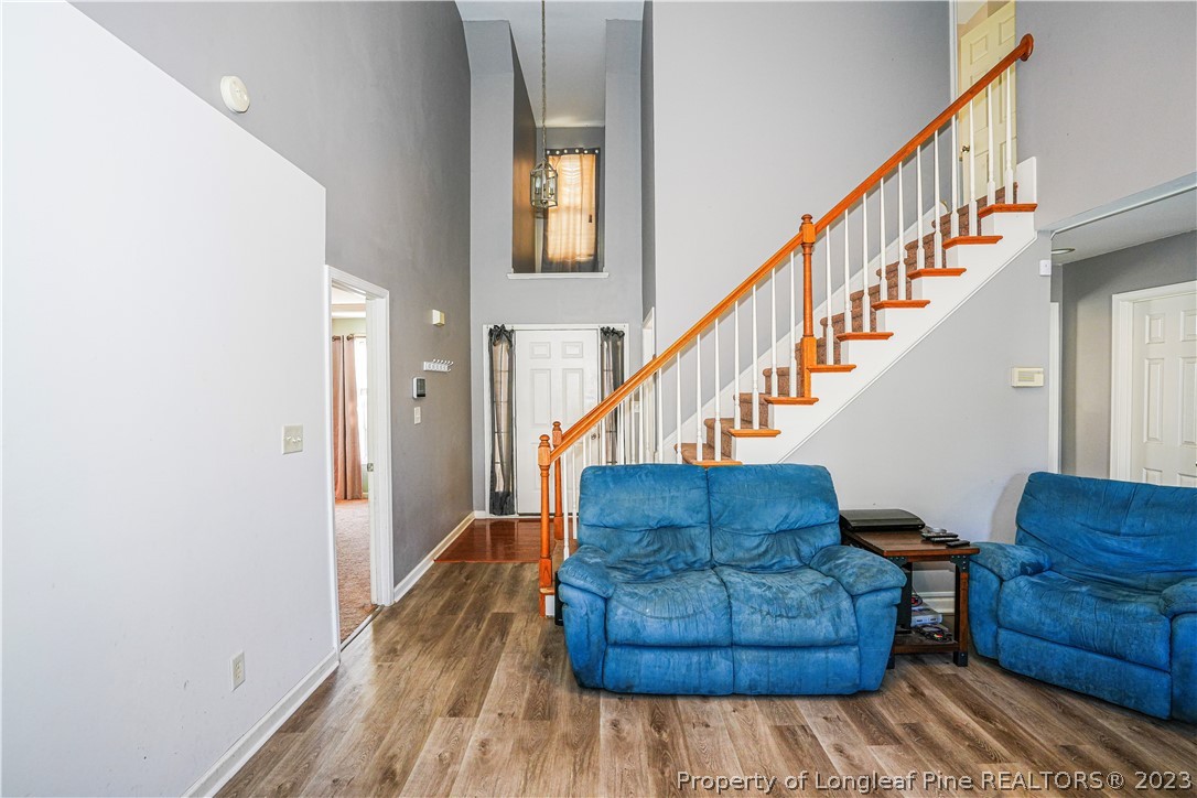 10 Pender Road Spring Lake, NC 28390 - Photo 5 of 30 a living room with couches and a dining table with wooden floor