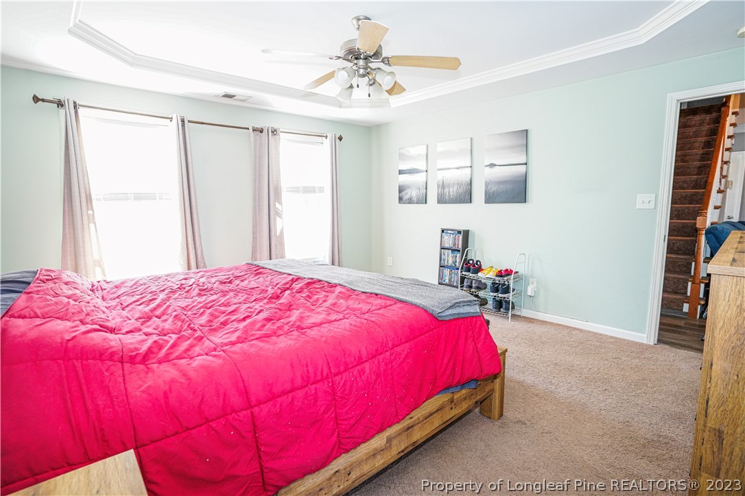 10 Pender Road Spring Lake, NC 28390 - Photo 9 of 30 a bedroom with a bed and a chandelier