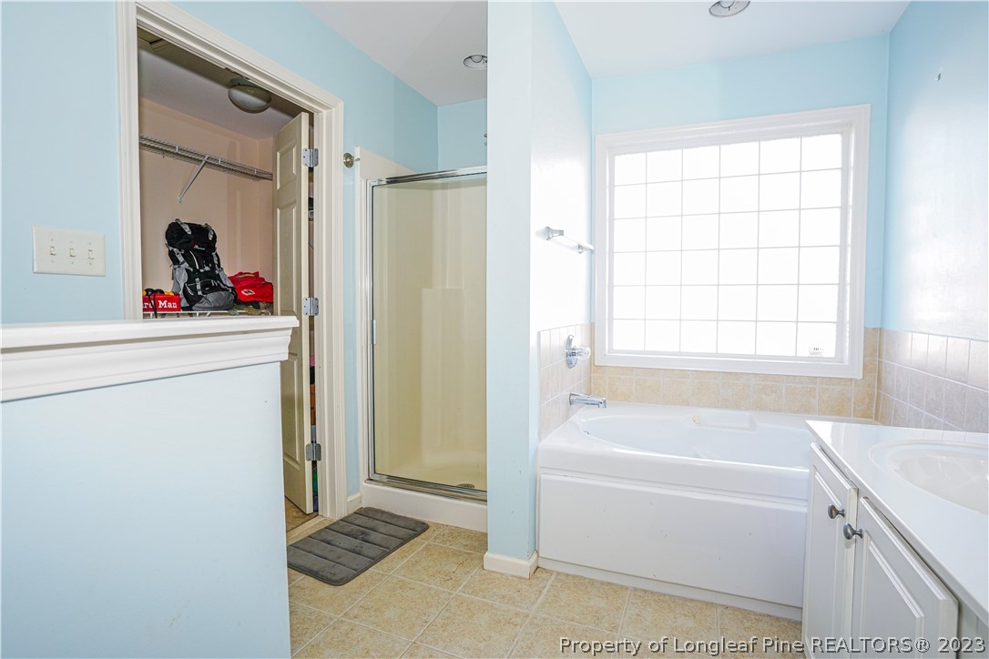 10 Pender Road Spring Lake, NC 28390 - Photo 10 of 30 a bathroom with a tub a sink and a window