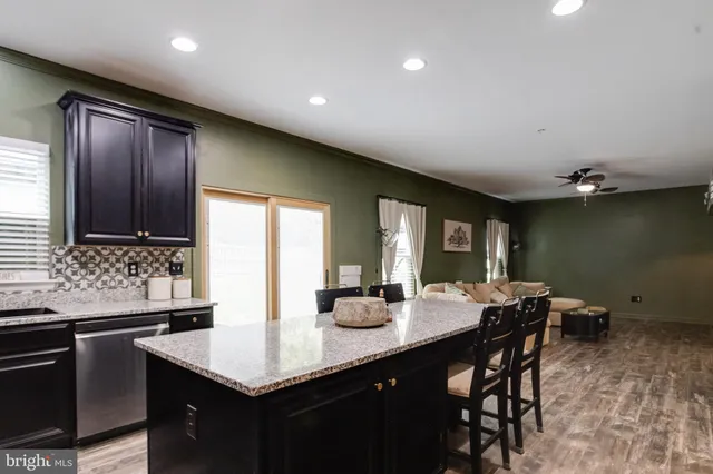 a kitchen with granite countertop sink table and chairs