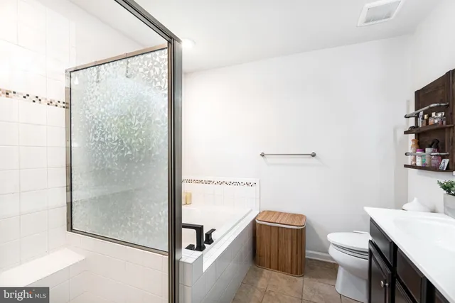 a bathroom with a toilet a sink and shower