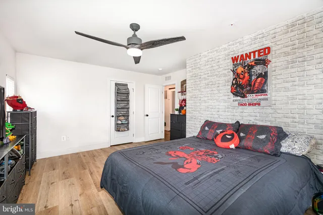 a bedroom with a bed and a bookshelf