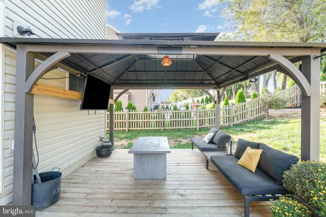 a view of yard from deck with patio