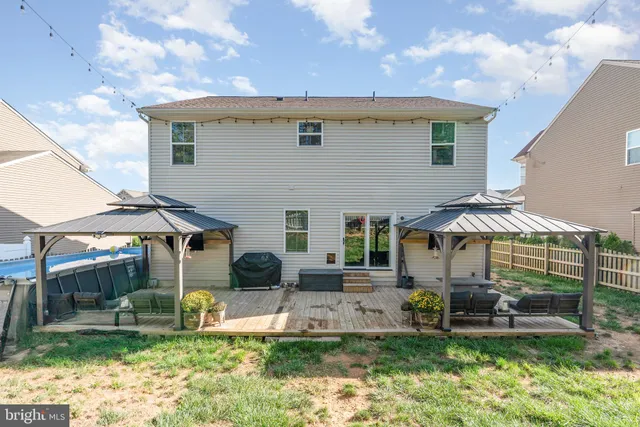 a backyard of a house with table and chairs