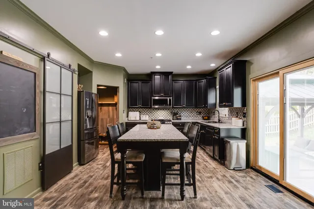 a large kitchen with a table and chairs