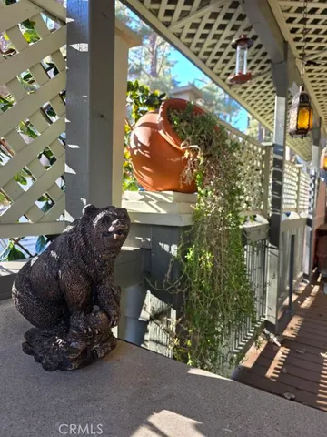 a room with a large window and potted plants