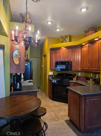 a kitchen with sink a stove and chairs