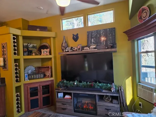 a living room with fireplace and a window