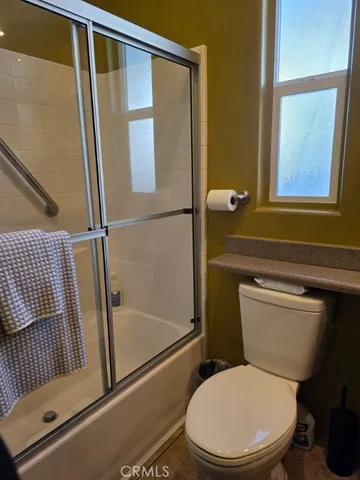 a white toilet sitting next to a bathroom sink