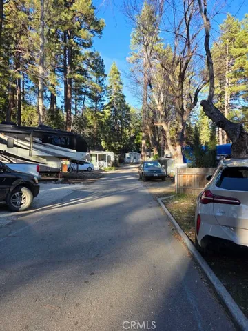 a view of car parked on the side of a street