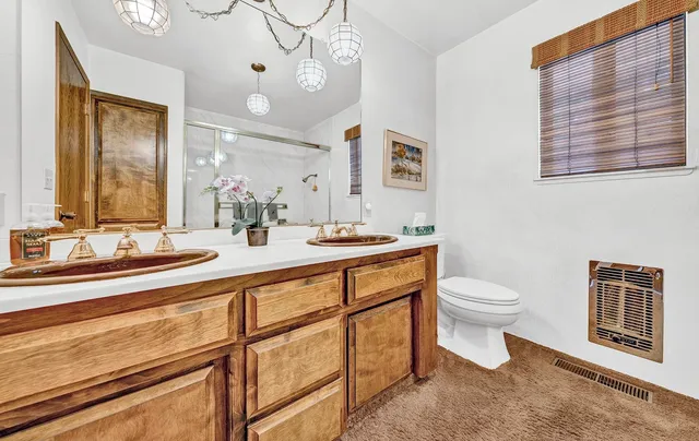 a view of bathroom with a sink and cabinets