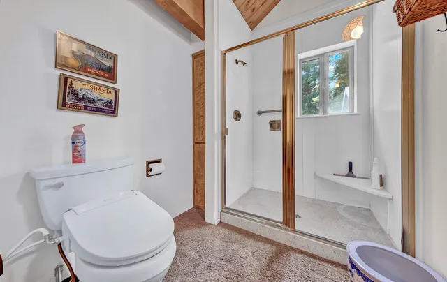 a front view of a house with a yard and potted plants