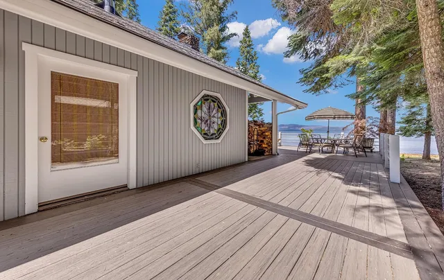 a living room with furniture a large window and a chandelier