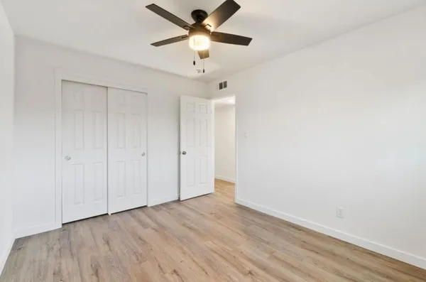 a view of an empty room and wooden floor