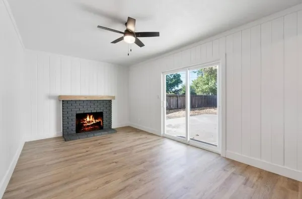 an empty room with floor fireplace and windows
