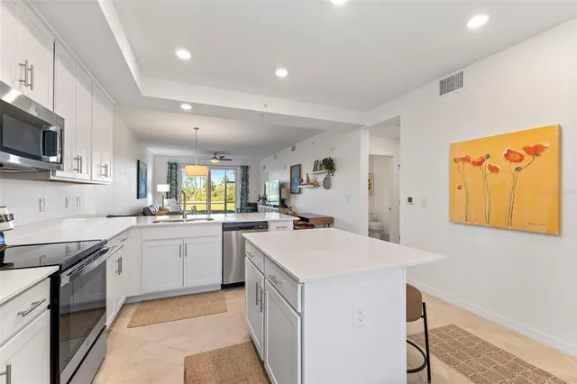 a kitchen that has a sink and a stove in it
