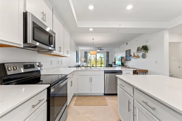 a kitchen with a sink a stove and microwave