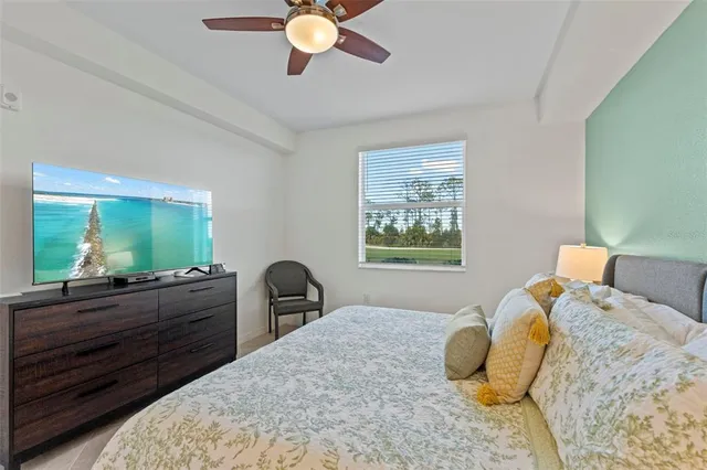 a bedroom with a bed and dresser with mirror