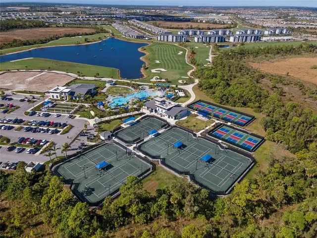 a view of a city with an ocean and houses