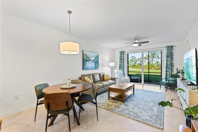 a living room with furniture and a floor to ceiling window