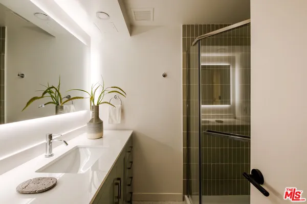 a bathroom with a granite countertop sink and a bathtub