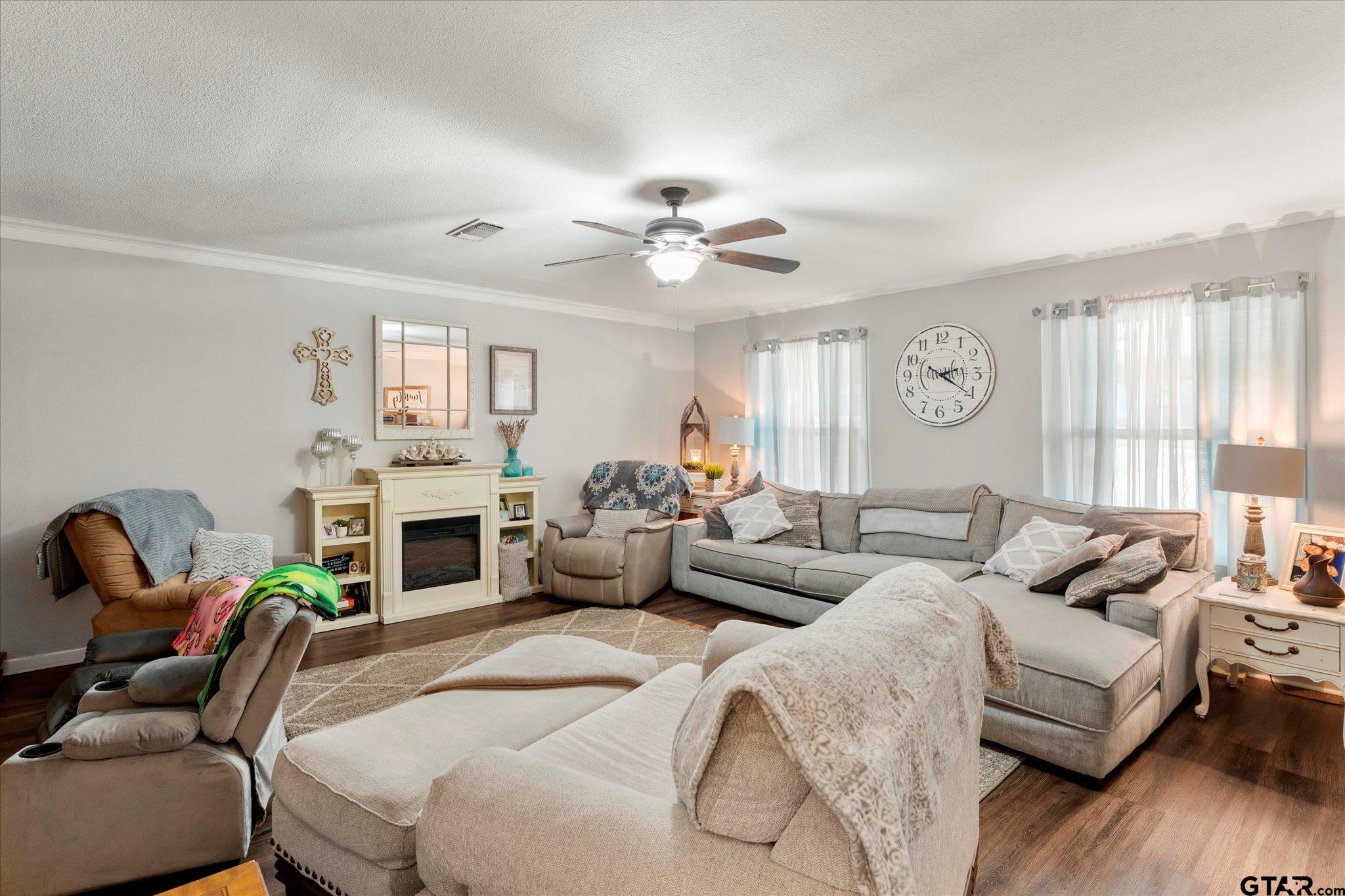 337 Daingerfield Street Pittsburg, TX 75686 - Photo 15 of 40 a bedroom with a bed couches and a fireplace