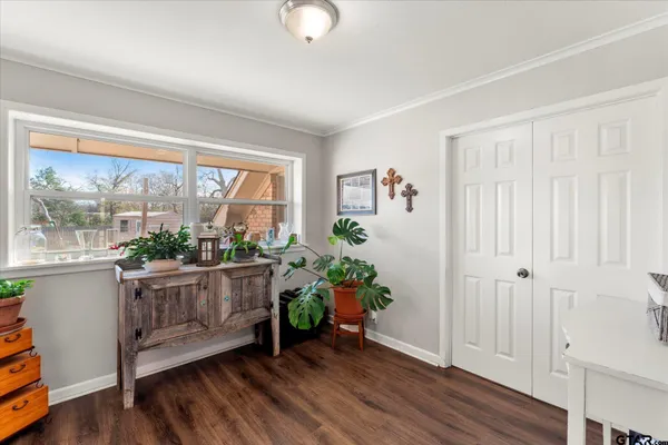 a bedroom with furniture and a large window
