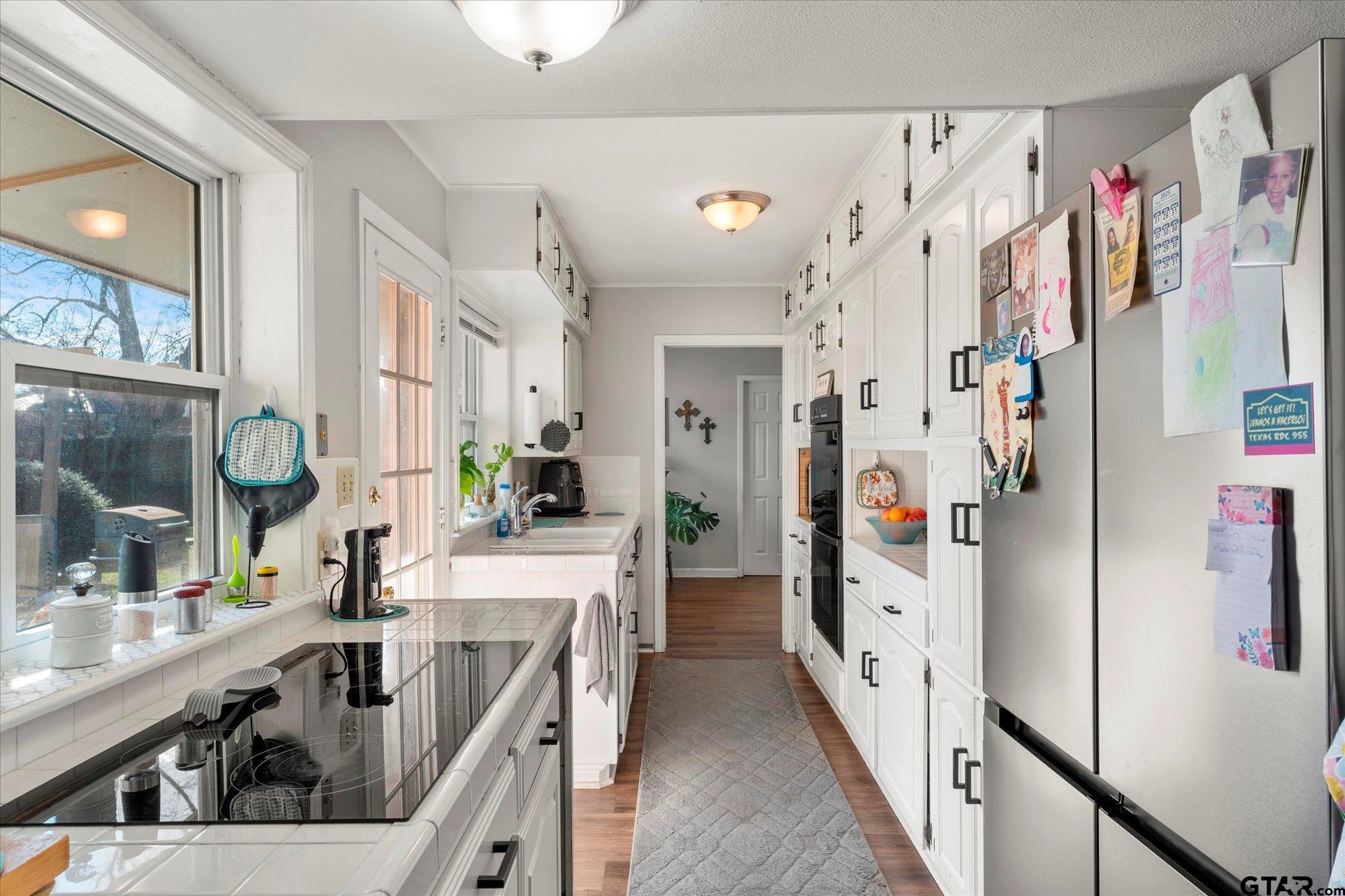 337 Daingerfield Street Pittsburg, TX 75686 - Photo 17 of 40 a kitchen with refrigerator and cabinets