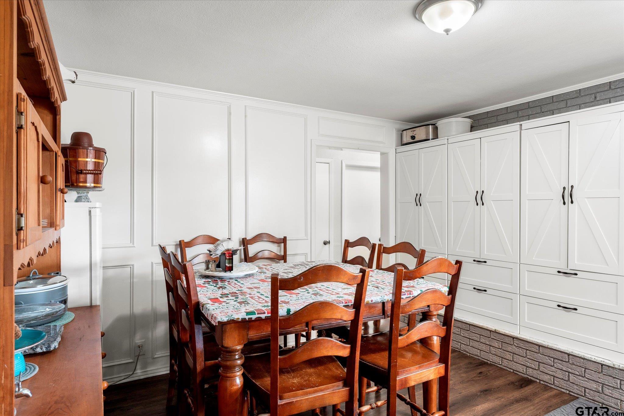 337 Daingerfield Street Pittsburg, TX 75686 - Photo 22 of 40 a view of a dining room with furniture and wooden floor