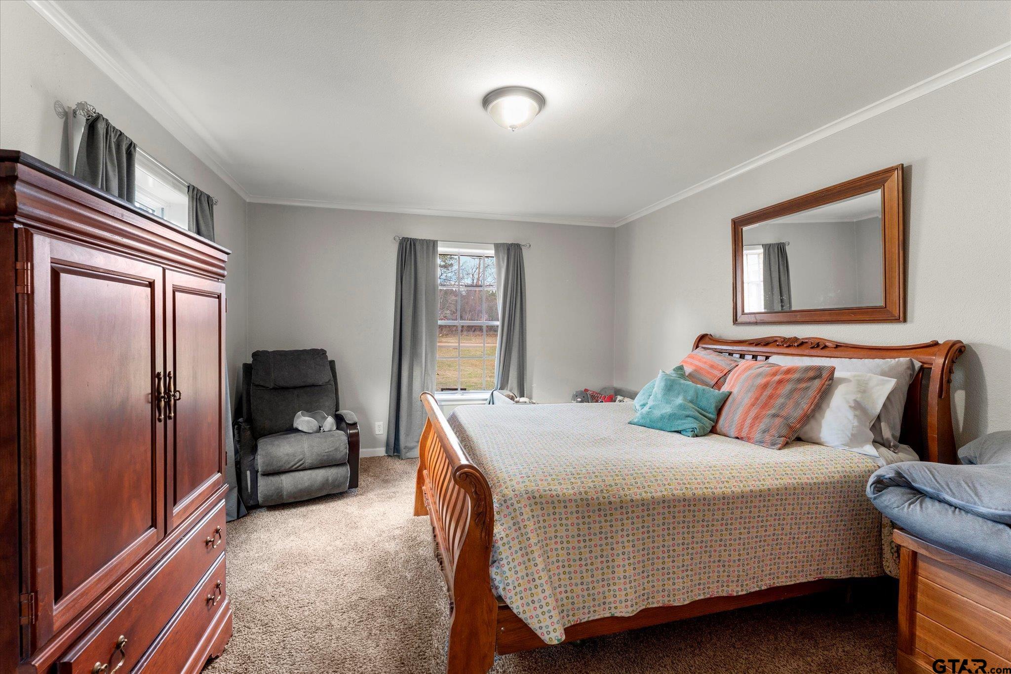 337 Daingerfield Street Pittsburg, TX 75686 - Photo 27 of 40 a bedroom with a bed and wooden floor