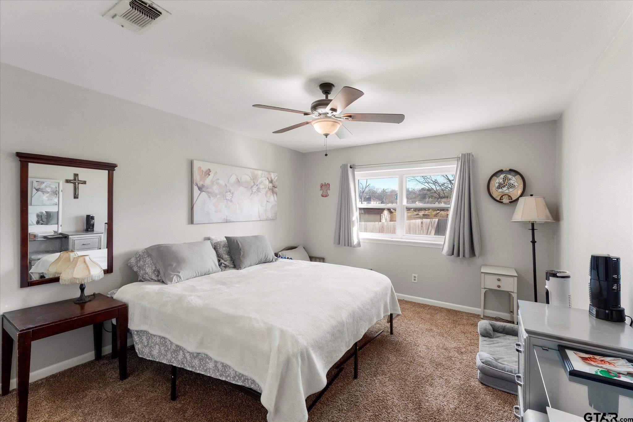 337 Daingerfield Street Pittsburg, TX 75686 - Photo 30 of 40 a bedroom with a bed and a window