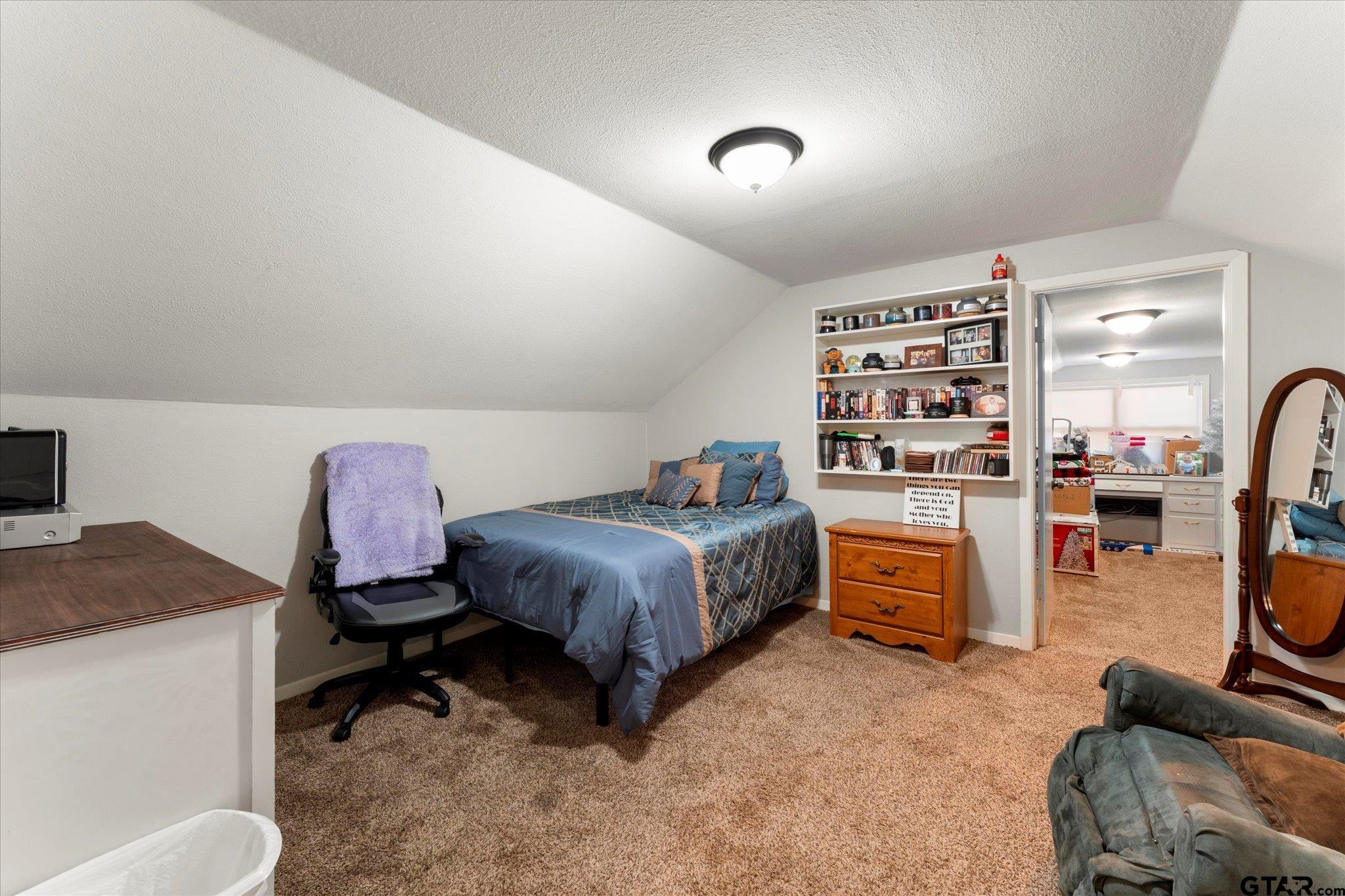 337 Daingerfield Street Pittsburg, TX 75686 - Photo 31 of 40 a bedroom with a bed and a view of kitchen