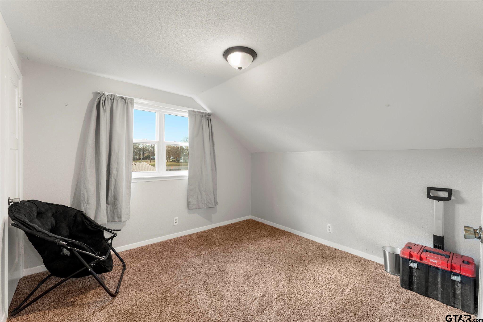 337 Daingerfield Street Pittsburg, TX 75686 - Photo 33 of 40 a room with gym equipment and a window