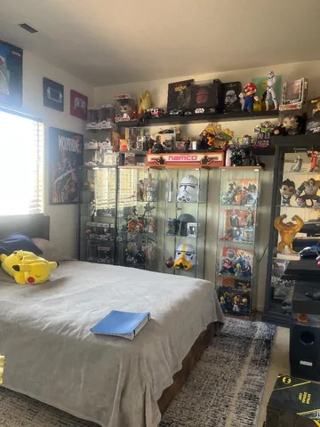 a bedroom with a bed and a window