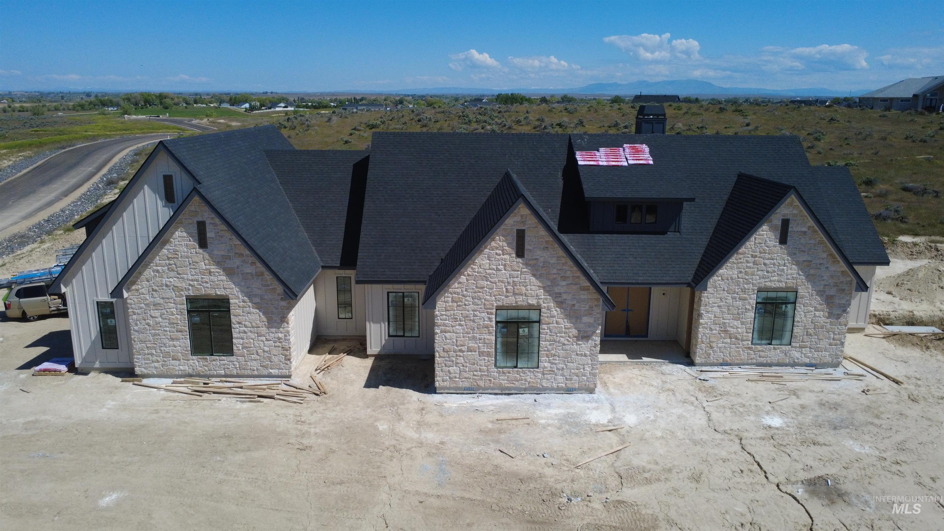 27502 Commerce Comet Way Caldwell, ID 83607 - Photo 1 of 8 Contemporary residence featuring light-toned stone and board-and-batten siding