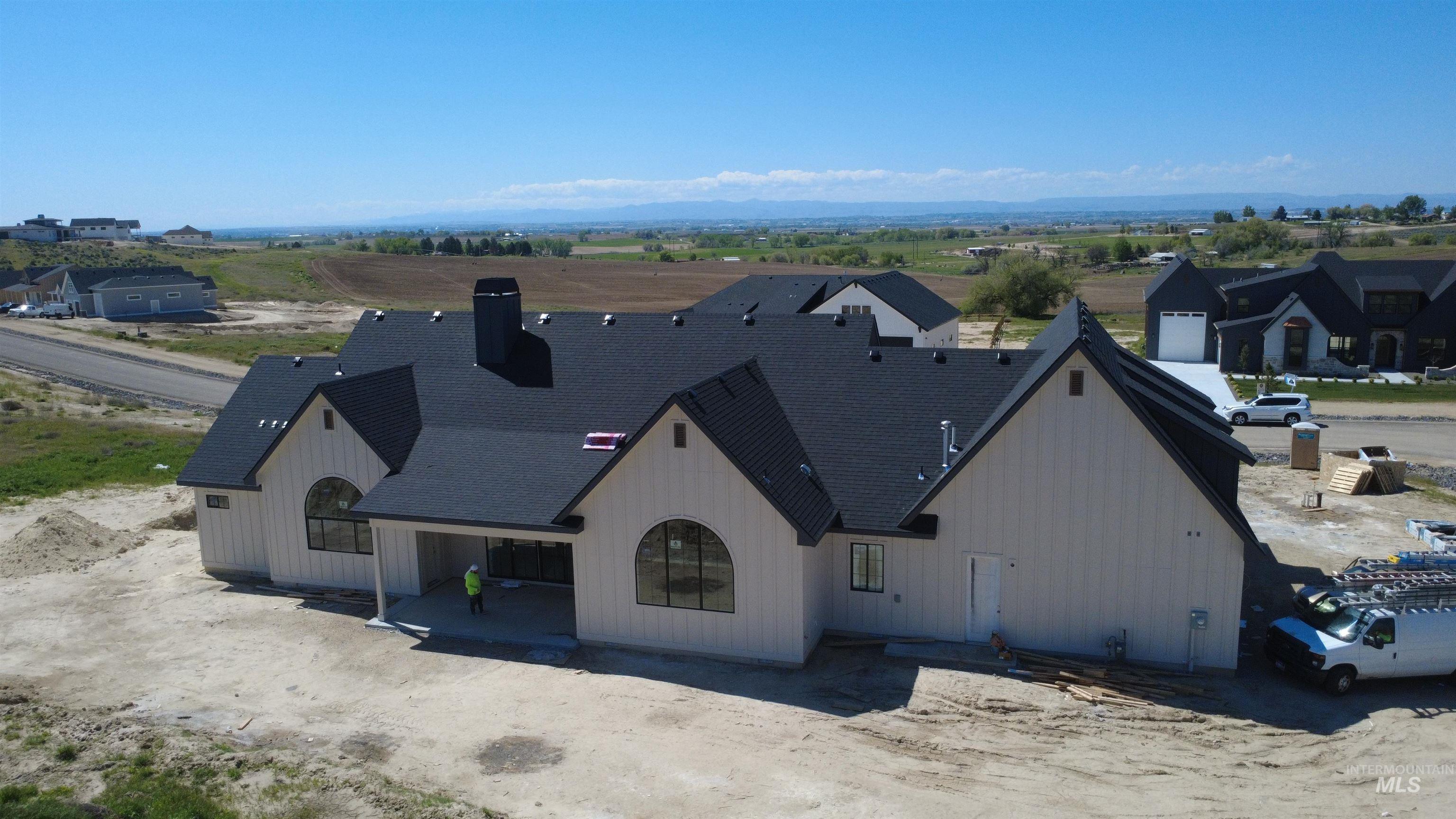 27502 Commerce Comet Way Caldwell, ID 83607 - Photo 6 of 8 Contemporary exterior architecture featuring a dark shingle roof and board and batten siding