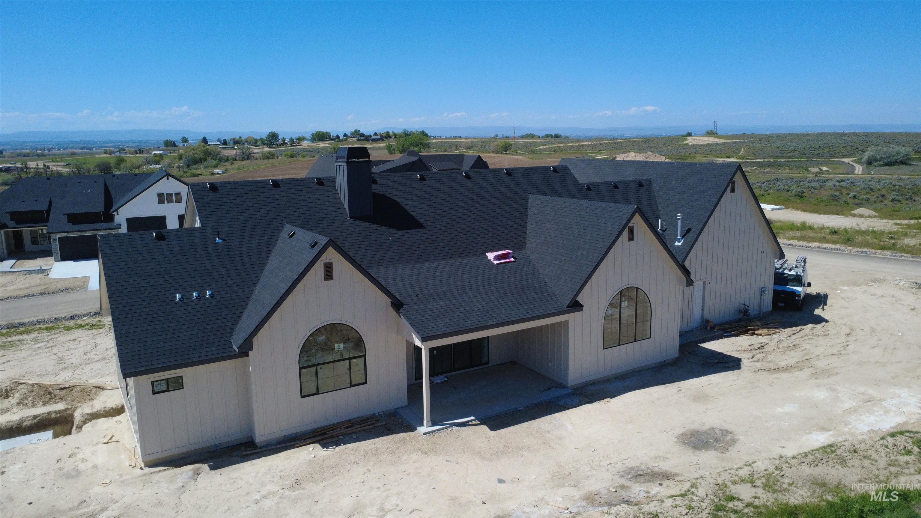 27502 Commerce Comet Way Caldwell, ID 83607 - Photo 7 of 8 New construction home featuring light-colored vertical siding and dark shingle roofing