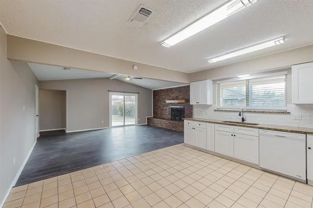 a kitchen with a sink cabinets and window