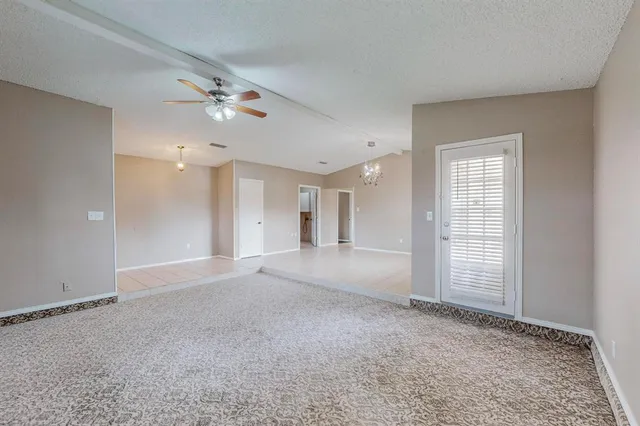 a view of empty room with ceiling fan