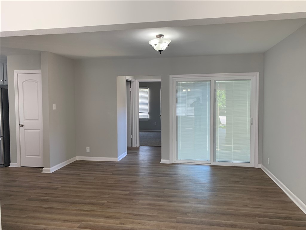 904 Cunningham Street Corpus Christi, TX 78411 - Photo 3 of 16 a view of an empty room with wooden floor and a bathroom