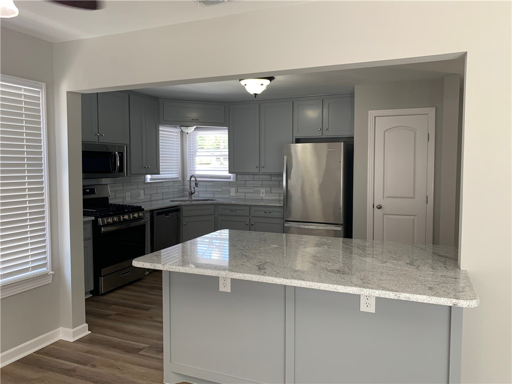 904 Cunningham Street Corpus Christi, TX 78411 - Photo 7 of 16 a kitchen with stainless steel appliances granite countertop a sink a stove and refrigerator