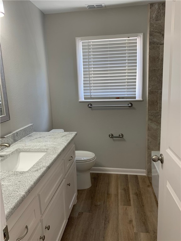 904 Cunningham Street Corpus Christi, TX 78411 - Photo 9 of 16 a bathroom with a granite countertop sink toilet and a mirror